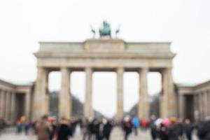 defocused Brandenburg Gate with tourist crowd in Berlin Germany photo