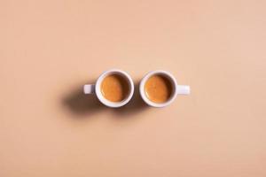 Two ceramic cups of espresso coffee. Top view. Minimalistic monochrome stock photo