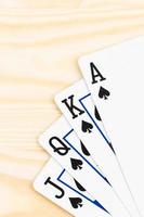 Royal flush poker playing cards on wooden background photo