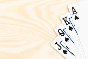 Royal flush poker playing cards on wooden background photo