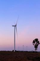 Wind turbine power generator at twilight photo