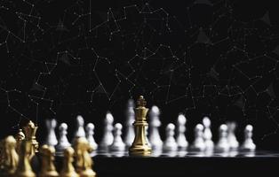 Golden king chess encounter with silver chess enemy on dark background and connection line for strategy idea and futuristic concept photo