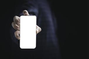 Businessman holding smartphone with blank screen frame template  for add advertisement and text. photo