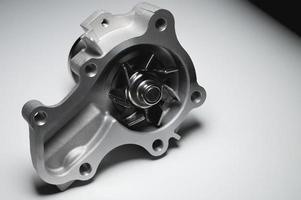 New auto Water pump on a gray gradient background. photo