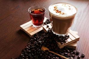 hot coffee and hot tea, coffee beans on wooden table photo
