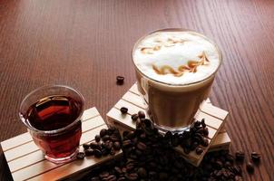 hot coffee and hot tea, coffee beans on wooden table photo