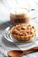 Almond tarts with hot latte on the table photo