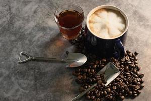 Hot latte with hot tea and coffee beans. photo