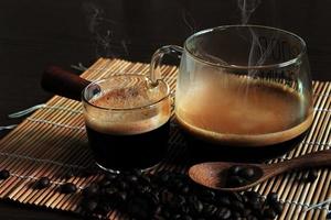 Strong hot coffee with beans on dark background photo