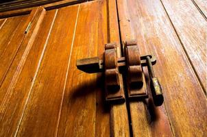 Wooden cabinet and lock at the door handle photo