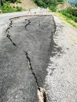 asphalt road cracked and broken texture photo