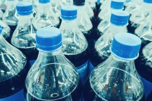 Carbonated soft drink bottles close up photo