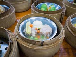 various dim sum in bamboo steamer photo