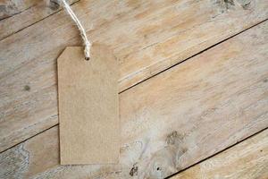 Blank price tag on wood background photo
