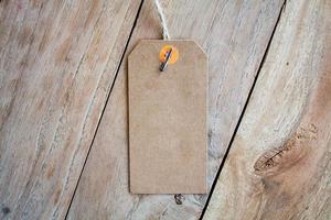 Blank price tag on wood background photo