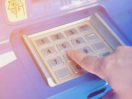 woman using ATM machine to withdraw money photo