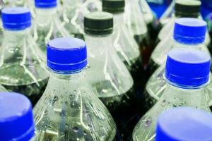 Carbonated soft drink bottles close up photo