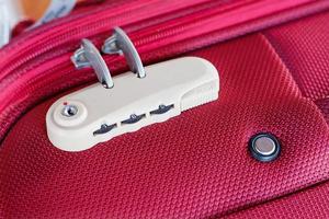 combination lock on red suitcase travel bag photo