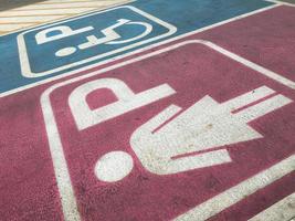 Lady and handicap sign in parking lot photo