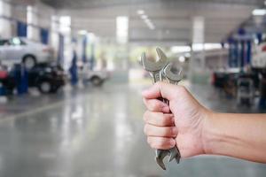 Hand of professional Auto mechanic with wrench photo