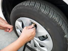 man filling air pressure in the car tyre photo