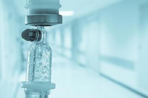 Medical drip with hospital blurred background photo