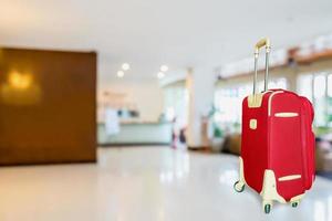 colorful suitcase with hotel lobby photo