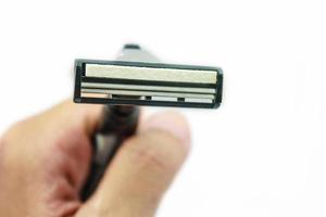 Hand with shaving razor isolated on a white background photo