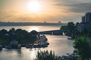 Boats and sunset in the lake marina photo