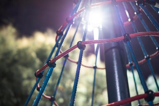 Climbing net in playground backlight at night clsoe up photo