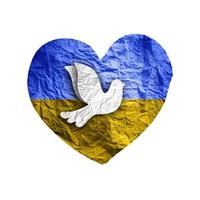 Flag of Ukraine in paper heart shape with dove of peace. Isolated on white. photo