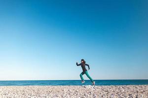 A girl on a morning jog on the beach photo