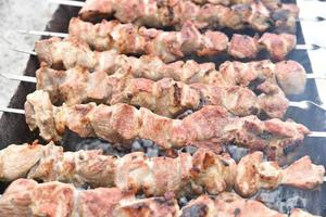 Pork meat shish kebab on a fire on coals photo
