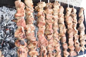 Pork meat shish kebab on a fire on coals photo