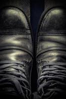 Casual gray leather shoes for men on wooden board.  Dark mood style. Top view. Vertical image photo