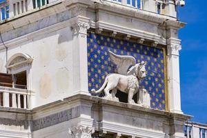 Statue of winged lion on the Clock Tower at Piazza di San Marco in Venice, Italy photo