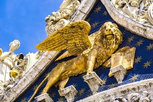 Lion of St Mark, symbol of imperial Venice on the Basilica San Marco in Italy photo