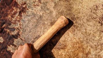 Someone is beating a drum made of cowhide. photo