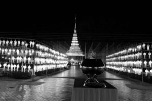 Beautifully shaped and colorful paper lanterns are hung in front of a pagoda to worship Lord Buddha in a temple in northern Thailand. photo