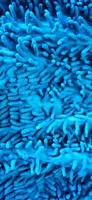 Close up of noodle textured blue microfiber mop carpet. photo