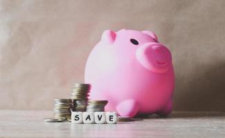 Save money concept, stack coins and save block word Save money for investment or education study with piggy bank background photo