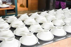 empty cup and spoon on the table, white cup bowl ready to serve for soup photo