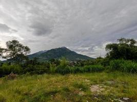 The appearance of Mount Merapi Boyolali, Central Java seen from the north side with agricultural land as foreground photo