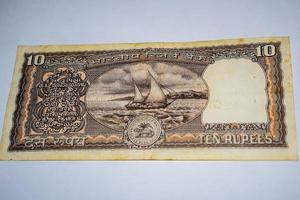 Rare Old Indian Ten rupee currency note on white background, Government of India ten rupee old banknote Indian currency, Old Indian Currency note on the table photo