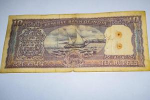 Rare Old Indian Ten rupee currency note on white background, Government of India ten rupee old banknote Indian currency, Old Indian Currency note on the table photo