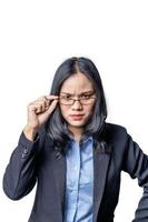 Portrait of a suspicious arrogant young businesswoman looking over her glasses. Confident Asian female business specialist with contemptuous glance looking at camera. Entrepreneur concept