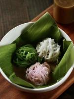 Top angle view of Indonesian Betawi string hopper dish called Putu Mayang cake, with noodles like shape, served w
