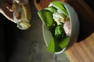 High angle view of Indonesian Betawi string hopper dish called Putu Mayang cake, with noodles like shape, served with liquid palm sugar. photo