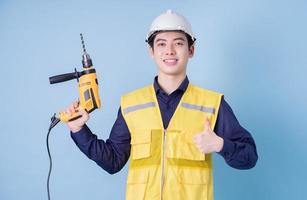 Construction worker portrait on blue background photo