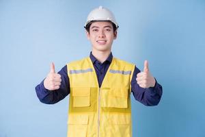 Construction worker portrait on blue background photo